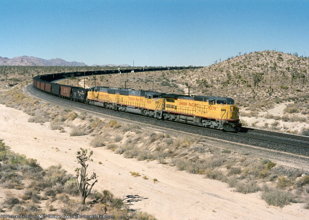 Union Pacific C40-8W #9379 (with SD60M's 6255 & 6311), in full dynamic braking, begins its slow descent down Cima Hill with a loaded coal train 